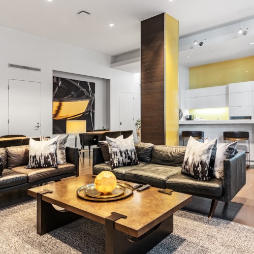 Resident lounge with comfortable sofas and a styled coffee table, creating an inviting space to relax or connect.