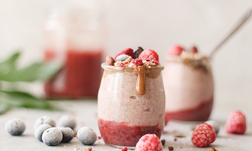 A fresh strawberry smoothie siting on a table 